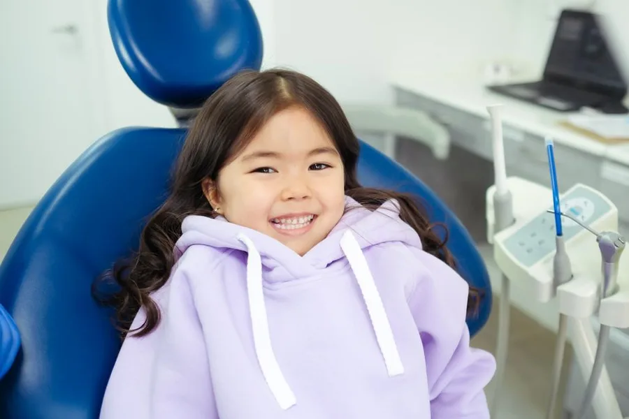 Smiling child in the chair at her Fort Myers pediatric dentist